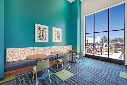 A room with a blue wall and a couch with a patterned cushion at Soul Apartments, St. Paul, Minnesota