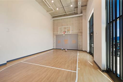 A basketball court with a wooden floor and a basketball hoop at Soul Apartments, St. Paul, MN 55107
