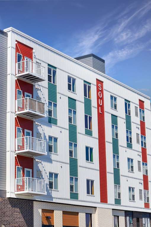 A white building with red and green stripes at Soul Apartments, St. Paul, 55107