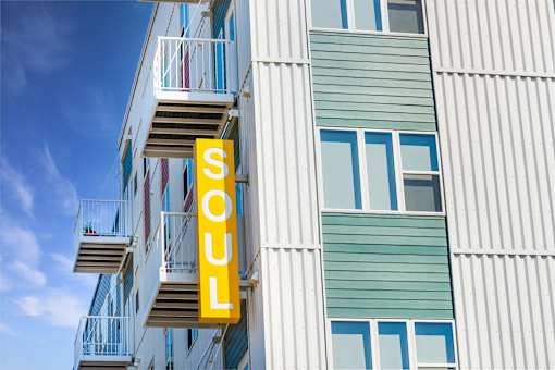 A building with a sign that says Soul on it at Soul Apartments, St. Paul, MN