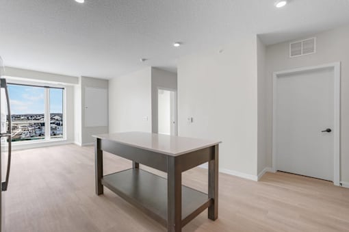 A modern room with a long table and a view of the outside.at Croft at Rosecott, Minnesota