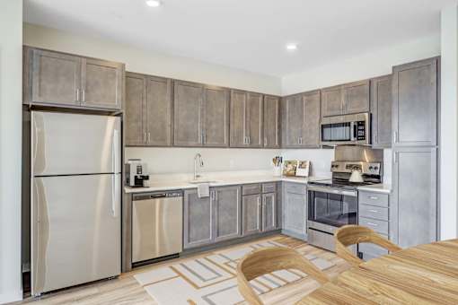 A Kitchen with a Refrigerator at Peregrine Apartments, Minneapolis, MN, 55411
