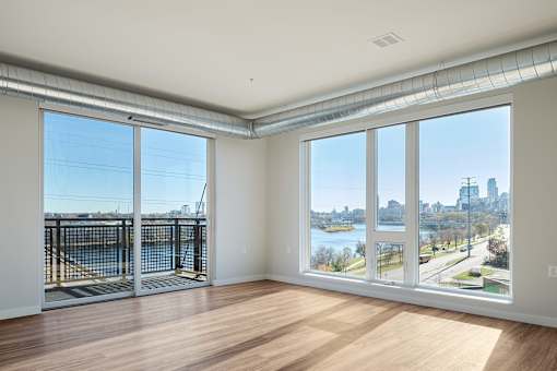 Living Room with Oversized Windows at Peregrine Apartments, Minnesota, 55411