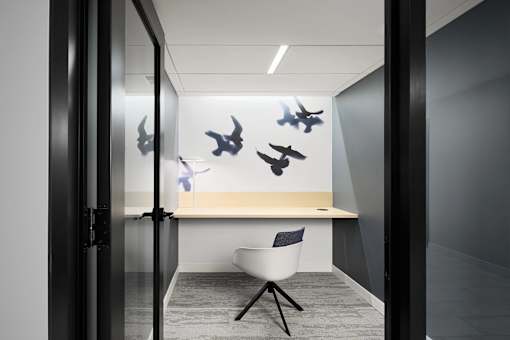 A Room with a White Desk and Chair at Peregrine Apartments, Minneapolis, MN, 55411