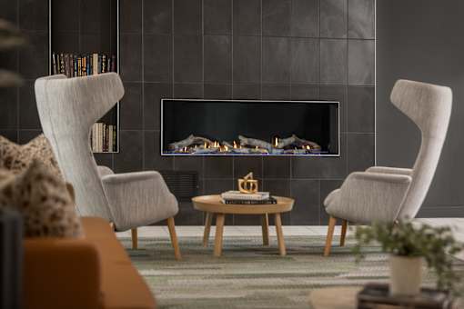 A modern living room with a fireplace and two chairs.