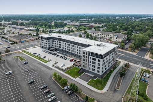 A large building with a parking lot in front of it.