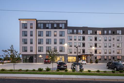 A large building with a parking lot in front of it.