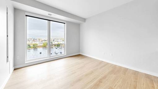 A room with a large window overlooking a cityscape.