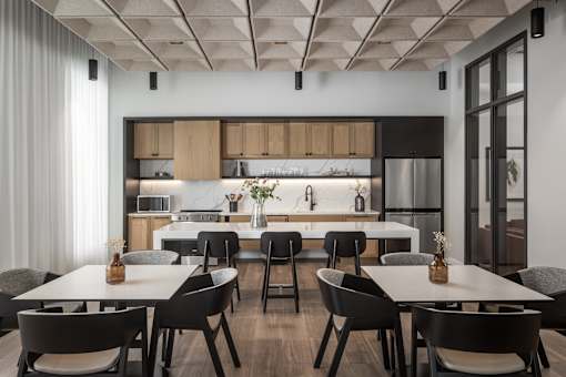 A modern kitchen with a dining table and chairs.