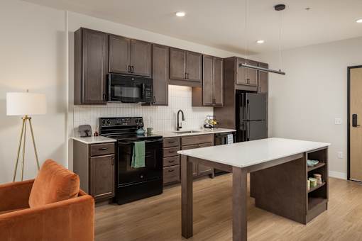 A modern kitchen with a brown and white color scheme.