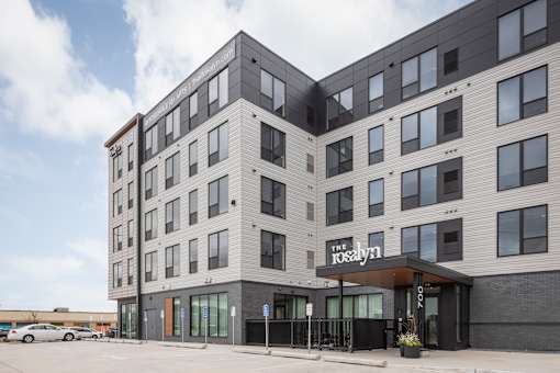 The Rosalyn is a modern multi-story building with a black and white exterior.
