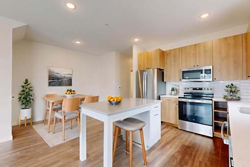 A modern kitchen with a dining table and chairs.