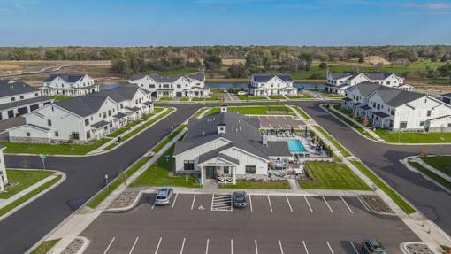A bird's eye view of a housing complex with a swimming pool.