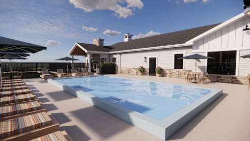 A large swimming pool in front of a house.