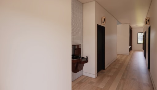 a hallway with white walls and wooden floors and a fireplace at Sandhill Parkway Townhomes Apartments, East Bethel, Minnesota