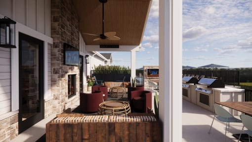 covered patio with furniture and a stone fireplace at Sandhill Parkway Townhomes Apartments, Minnesota, 55011