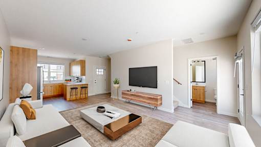 A modern living room with a white sofa and a wooden coffee table.