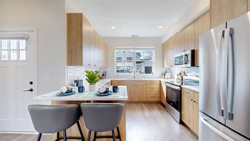 A modern kitchen with a dining table and chairs.