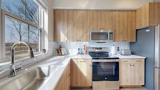 A kitchen with wooden cabinets and stainless steel appliances.