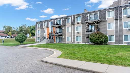 Apartment building with a green lawn in front.