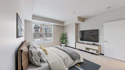 A bedroom with a large bed and a flat screen TV.