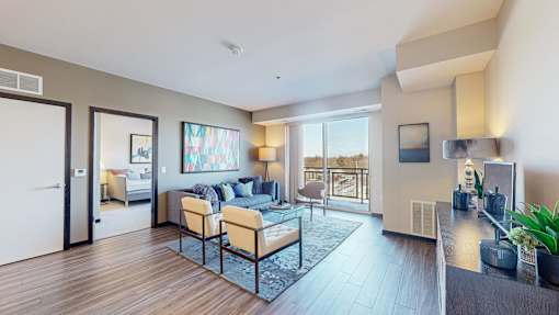 A modern living room with a couch, chairs, and a coffee table.