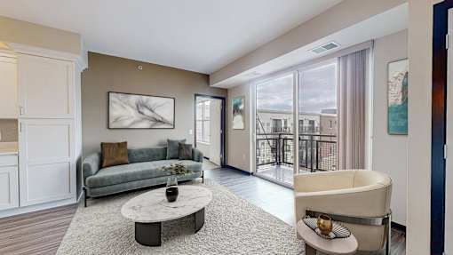 A living room with a grey couch and a coffee table.