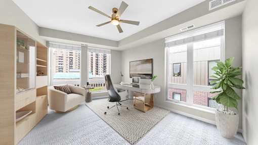 A living room with a ceiling fan and a grey carpet.