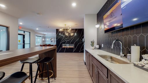 a kitchen with a long counter and stools in front of it at The Morrison, Rosemount Minnesota