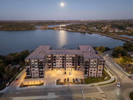 A large building with a parking lot in front of it.