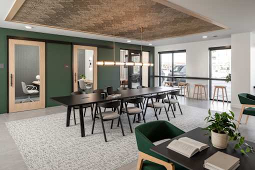 A conference room with a long table and chairs.