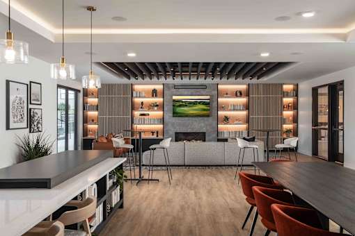 A modern dining room with a long table and chairs.