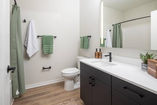 A bathroom with a white toilet and a white sink.