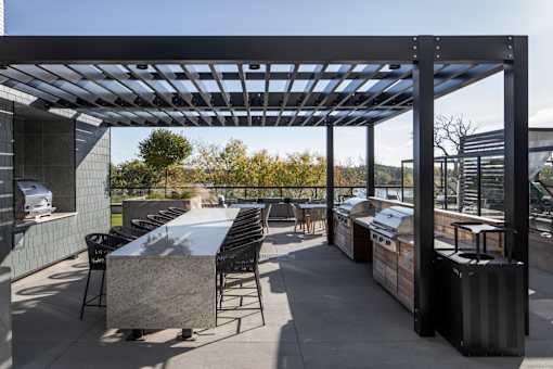 A patio with a table and chairs under a roof.