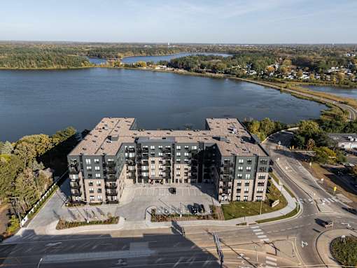 A large building with a parking lot in front of it.