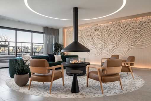 A modern living room with a fireplace and comfortable seating.