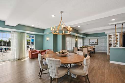 A dining room with a round table and chairs.
