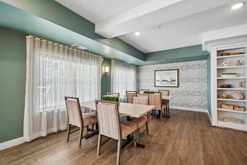 A dining room with a table set for six.