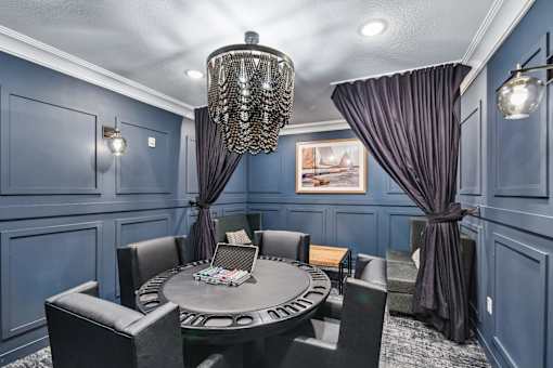 A dining room with a round table and chairs.