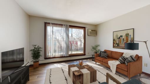 a living room with a couch and a coffee table in front of a large window