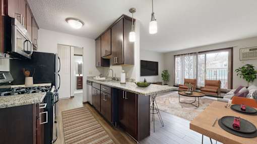 A modern kitchen with dark wood cabinets and a black refrigerator.