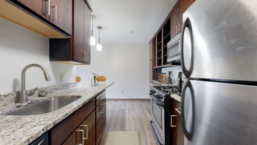a kitchen with wood cabinets and granite countertops