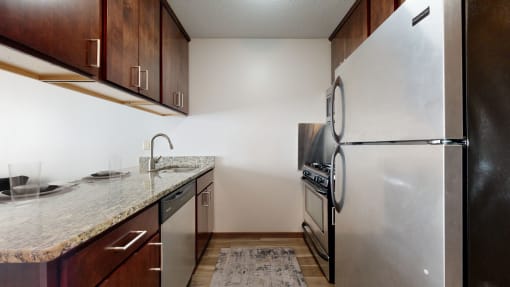 a kitchen with stainless steel appliances and a granite counter top