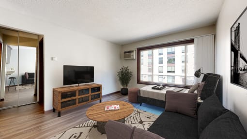 a living room with a large window and a couch
