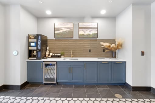 a kitchen with blue cabinets and a coffee machine