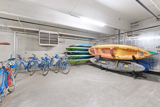 a row of bikes and kayaks in a garage