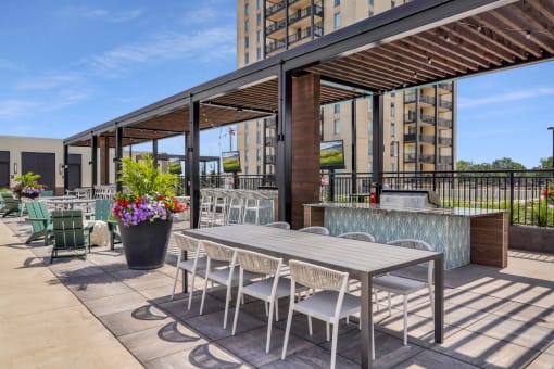 a patio with a table and chairs and a bar at The Gateway at West Lake Quarter in Minneapolis, MN