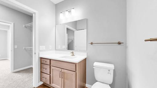 A white toilet sits next to a sink in a bathroom.