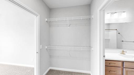 A white bathroom with a walk-in shower and a sink.