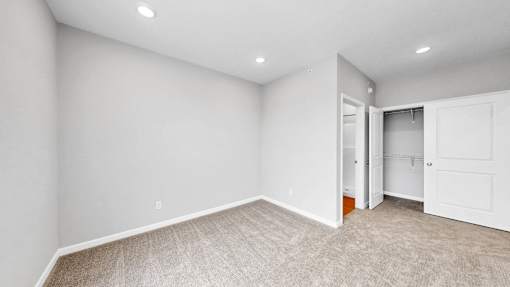 A room with a carpeted floor and white walls.
